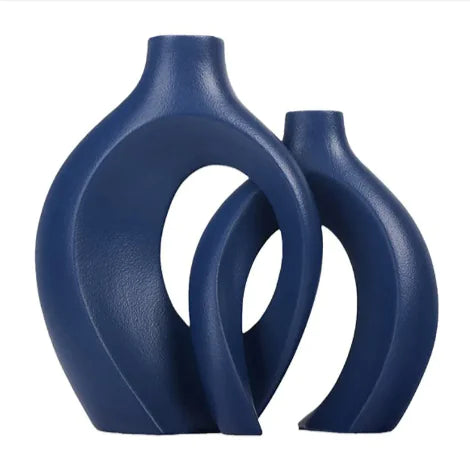 Two blue ceramic vases with a modern design on a white background