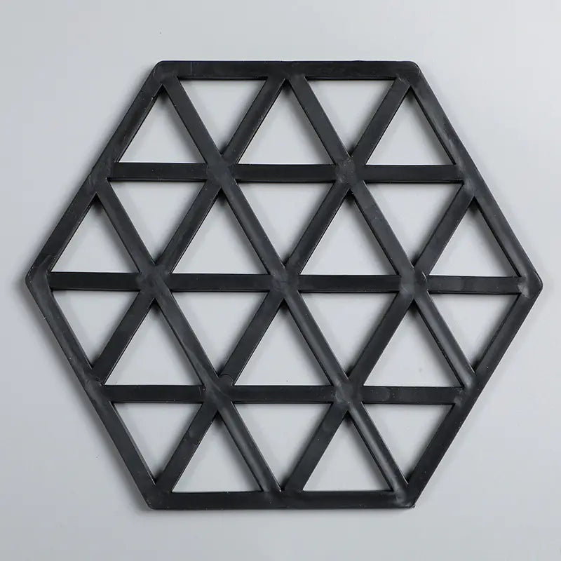 Black geometric hexagonal tray on a light gray background
