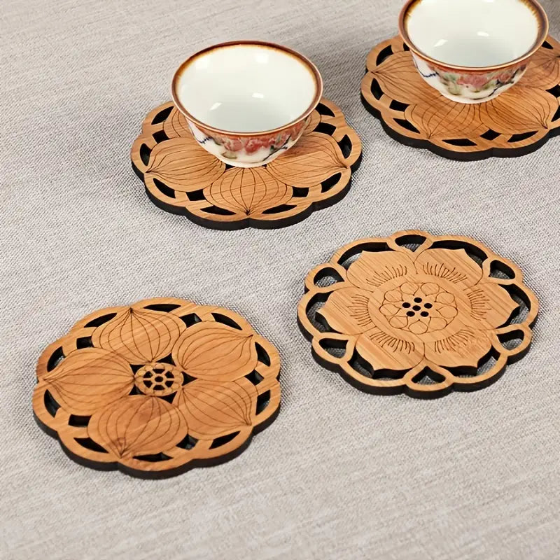 Set of decorative wooden coasters with floral patterns on a textured surface.
