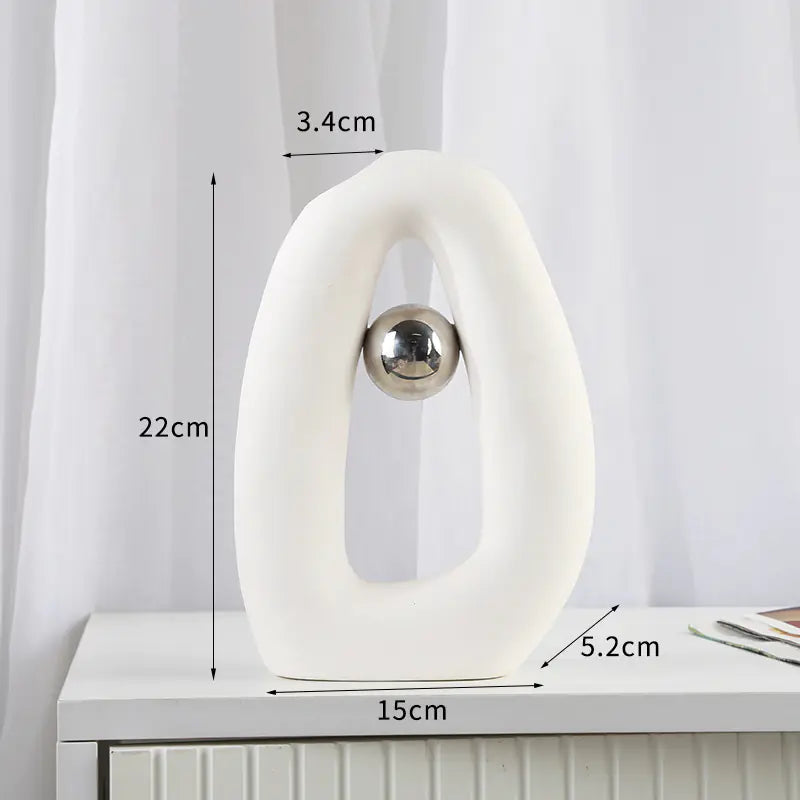 White decorative object with measurements on a white surface