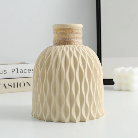 Beige textured vase with woven top on a light surface