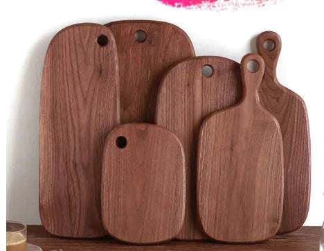 Set of wooden cutting boards of various sizes on a white background