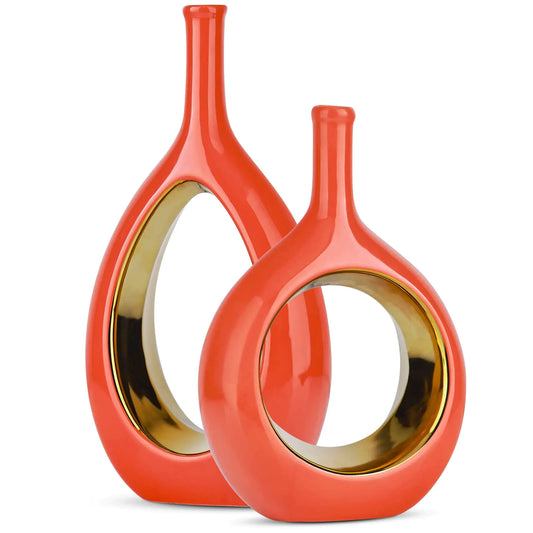 Two orange vases with gold interior rings on a white background